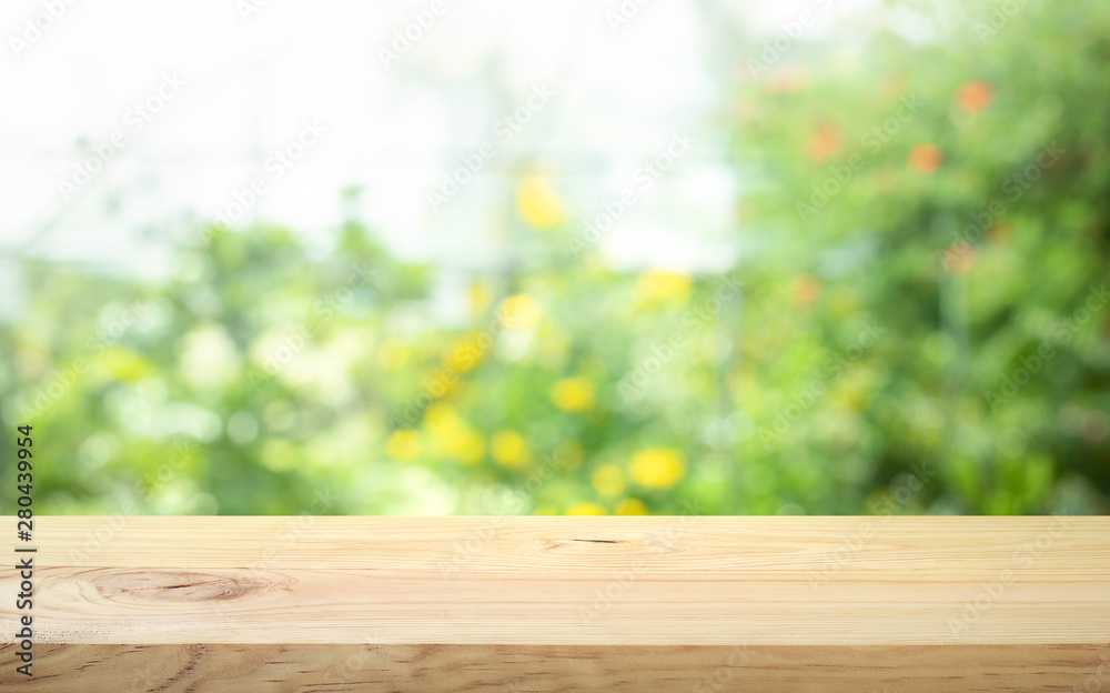 Real wood table top texture on blur flower garden background.For create product display or design key visual Real wood table top texture on blur flower garden background.For create product display or design key visual