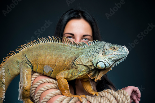 perfect bodyes sensual woman with iguana dragon in the studio