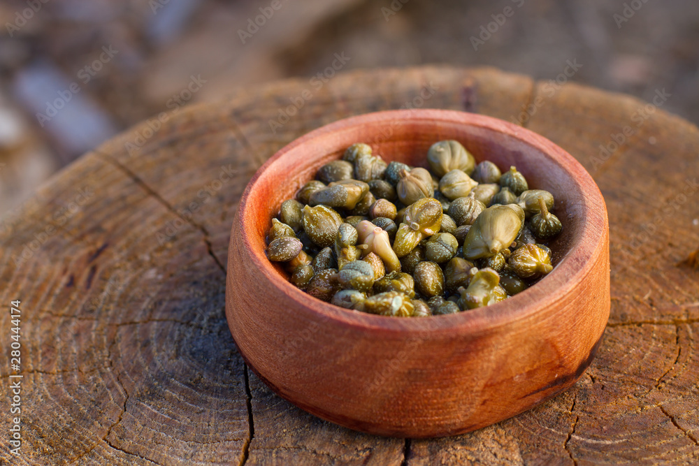 caper in a wood bowl caper in a wood bowl