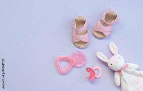 the pink baby shoes, pacifier, teether and rabbit toy
