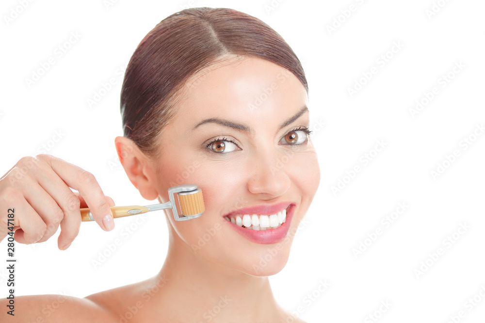 Beauty girl using skin roller.