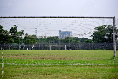 Empty soccer field in a sports complex, Picture is captured behind soccer goal.