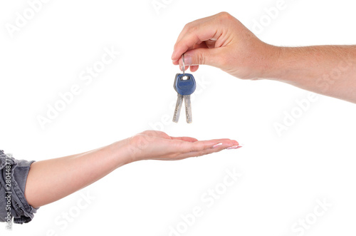 A man gives the keys to the lock of a woman close-up on a white background. male and female palms with keys.
