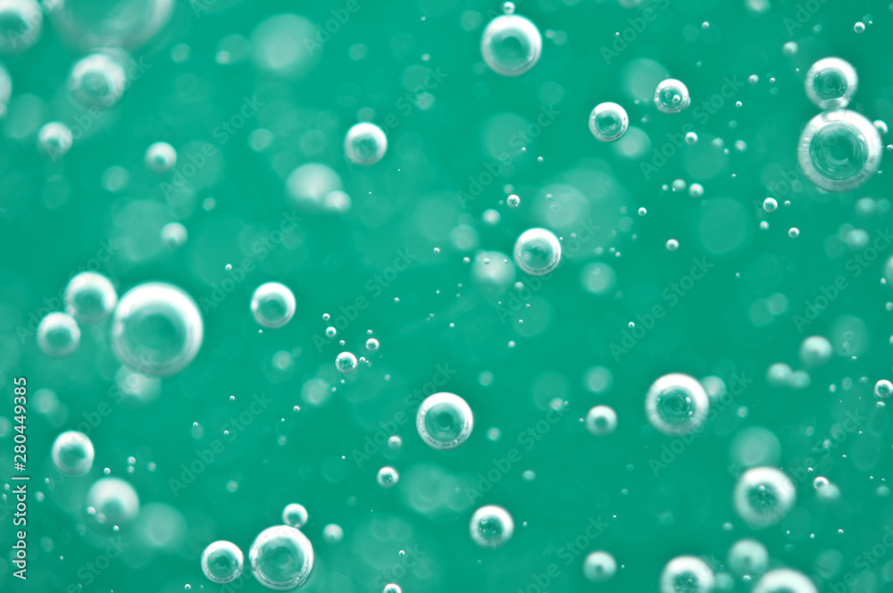 Beautiful turquoise background. Rising air bubbles in clear water. Oxygen. Macro