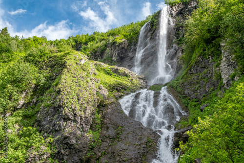 Views of the green mountains with the highest waterfall. Clear blue sky