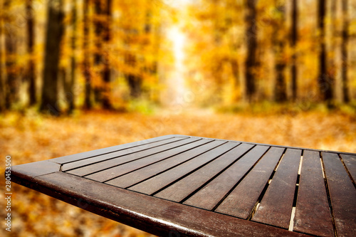 Autumn background and wooden desk of free space 