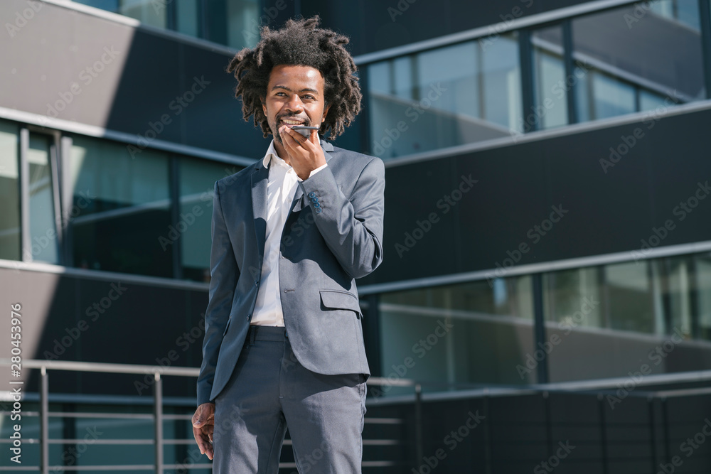 Businessman using cell phone outside office in the city Businessman using cell phone outside office in the city