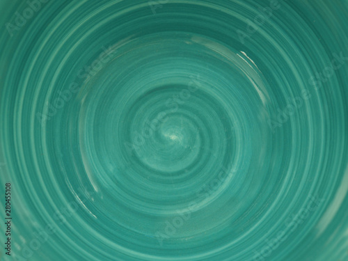  the bottom of the plate is turquoise in color with a swirl pattern