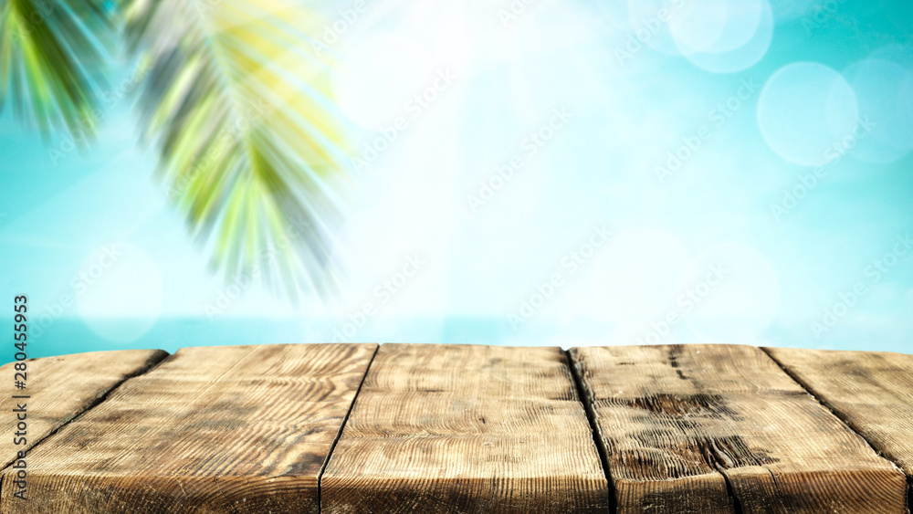 Table background with beautiful blue ocean and sandy beach view. Summer sunny day in distance. Table background with beautiful blue ocean and sandy beach view. Summer sunny day in distance.