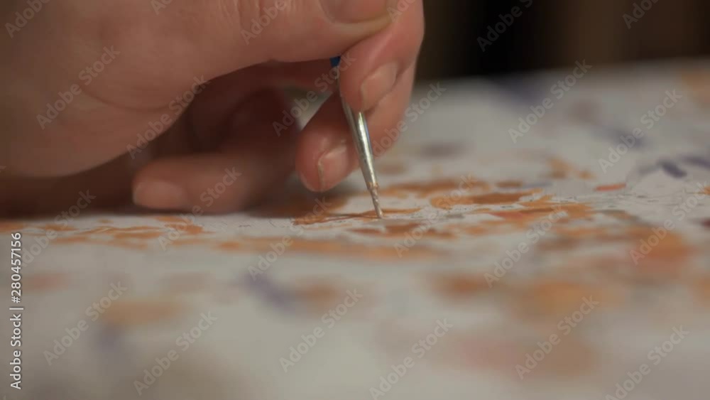 emale hand draws a brush on canvas emale hand draws a brush on canvas