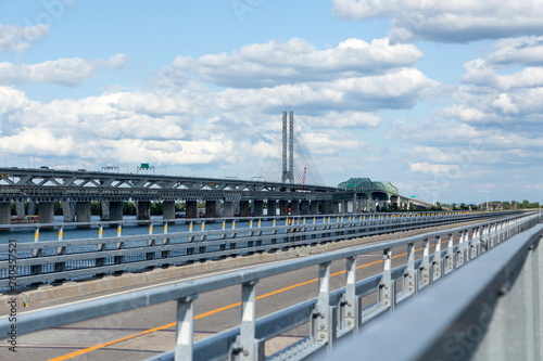 Horizontal view of the two Samuel-de-Champlain bridges and the Ice Control Structure over the St. Lawrence river seen from the Nun’s Island’s bicycle path during a beautiful summer day, Montreal photo