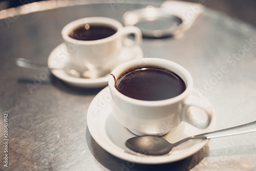 Cups with hot chocolate - high-calorie dessert - selective focus