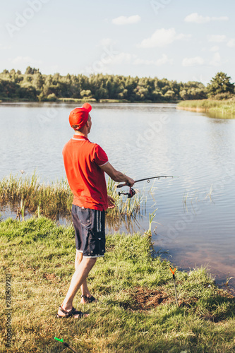 Fisherman on the beach closely watching the float on a fishing rod