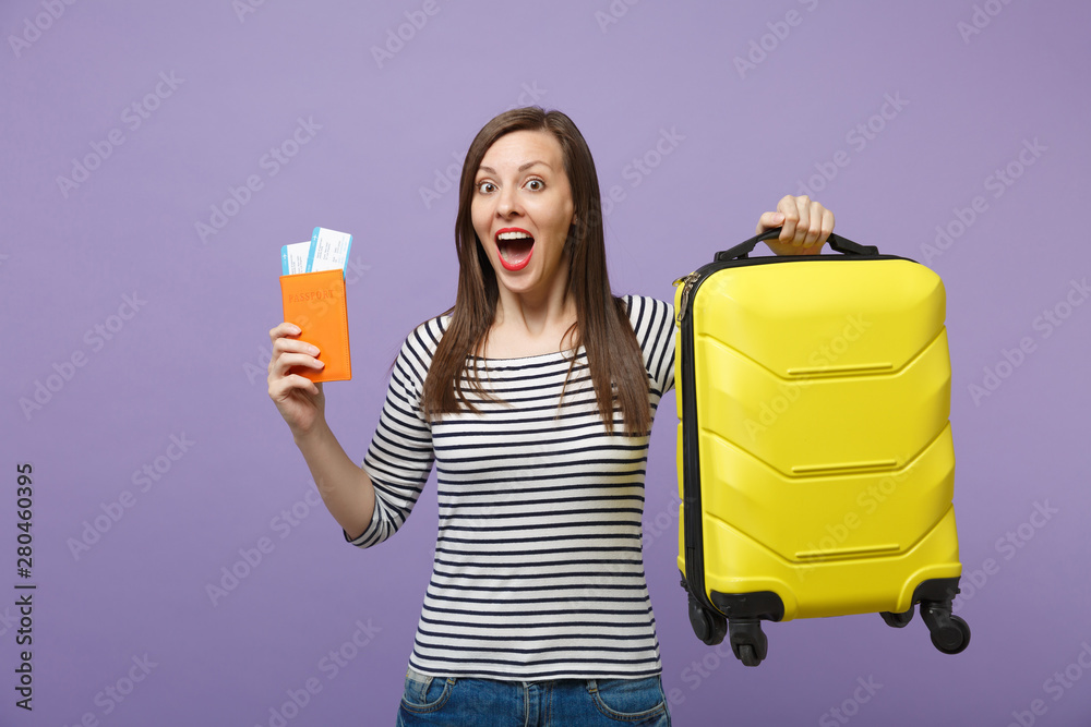 Traveler tourist woman girl in casual striped clothes posing isolated on violet purple background studio portrait. Passenger traveling abroad to travel on weekends getaway. Air flight journey concept. Traveler tourist woman girl in casual striped clothes posing isolated on violet purple background studio portrait. Passenger traveling abroad to travel on weekends getaway. Air flight journey concept.
