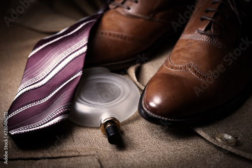 set of classic mens clothes, brown shoes, perfume and tie
