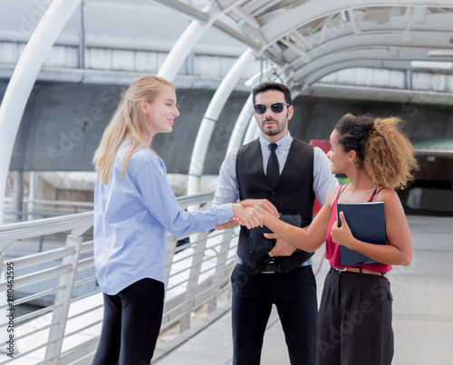 Modern young busines are talking to exchange business experiences in the city center.  © NONTANUN