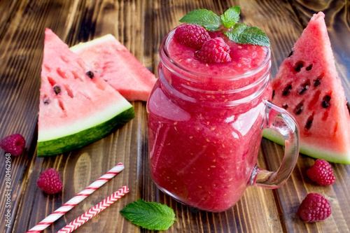 Smoothies from watermelon and raspberries  on the bown  wooden background photo