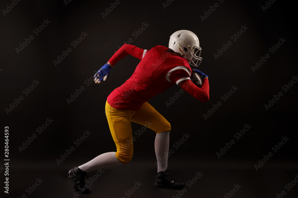 Full-lenght photo of running girl in white helmet with rugby ball in her hand in studio