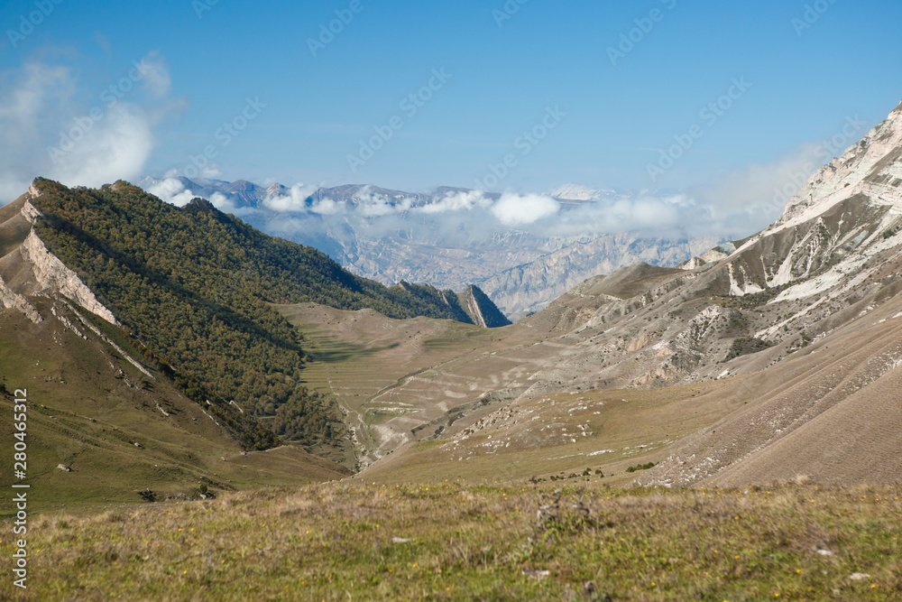 Image of mountain area with blue clear sky, green field on summer