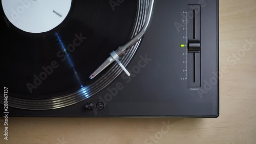 top view on black modern turntable with rotating LP record photo