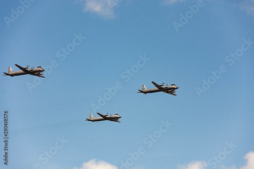 Dress rehearsal of parade July 25, 2019 in St. Petersburg. Day of Navy in Russia. Air part of parade. Military aircraft in sky. Airplane on blue background. Group of planes