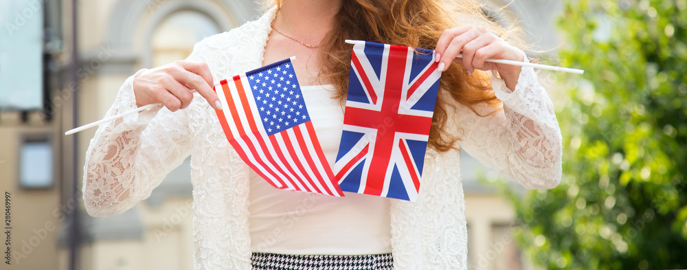 Close of two flags of USA and Great Britain female hands. Friendship between countries. Travel and learn English. Stock Photo | Adobe Stock