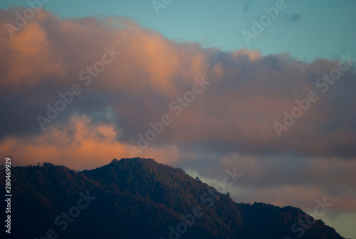 Mountain silhouette at sunset and clouds in the natural color sky, open spaces in Guatemala