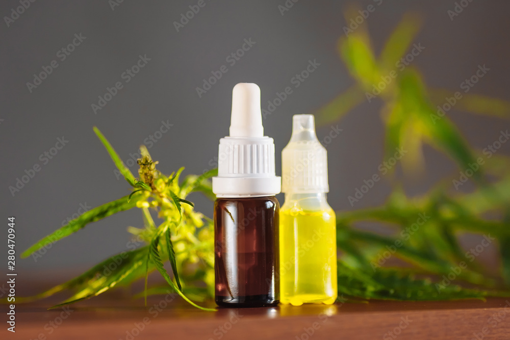 Wellness Hemp Cannabidiol, bottle of CBD oil on cannabis background. Premium marijuana products. Medical cannabis with extract CBD. A place for copy space Wellness Hemp Cannabidiol, bottle of CBD oil on cannabis background. Premium marijuana products. Medical cannabis with extract CBD. A place for copy space