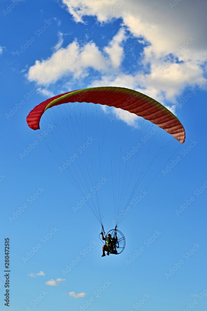 Man flying paraglider for concept design. Travel concept. Freedom, recreation, extreme sport. Summer. Man flying paraglider for concept design. Travel concept. Freedom, recreation, extreme sport. Summer.
