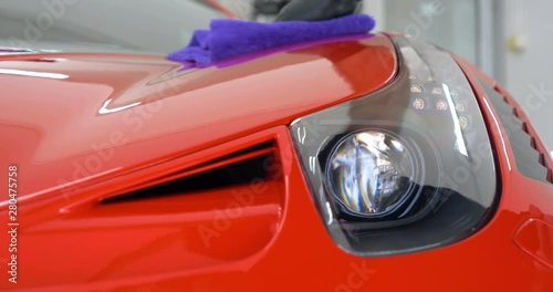 Professionals wear Chemical protective clothing at work.Car Care Business. Automobile industry. Car wash and coating business with ceramic coating.Spraying the varnish to the car.