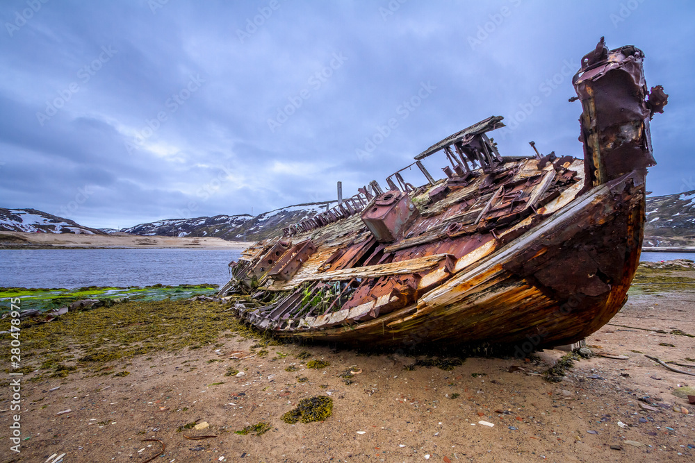 Old rusty rotten boat on Teriberka. Russian north