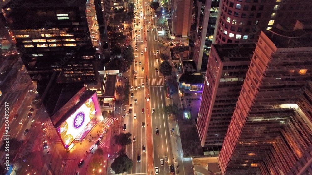 Obraz premium Aerial view of city at night with iluminated avenue. Great landscape.