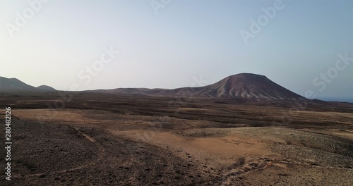 sunset between volcanoes and desert landscapes and wild nature