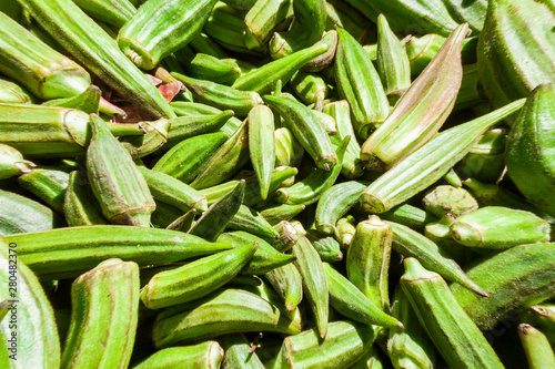 Green organic vegetables sell, Clemson Spineless Okra, Abelmoschus esculentus, with strong sunlight, in Street market in Guanabano Bridge in La Baralt Avenue, Caracas, Venezuela. photo