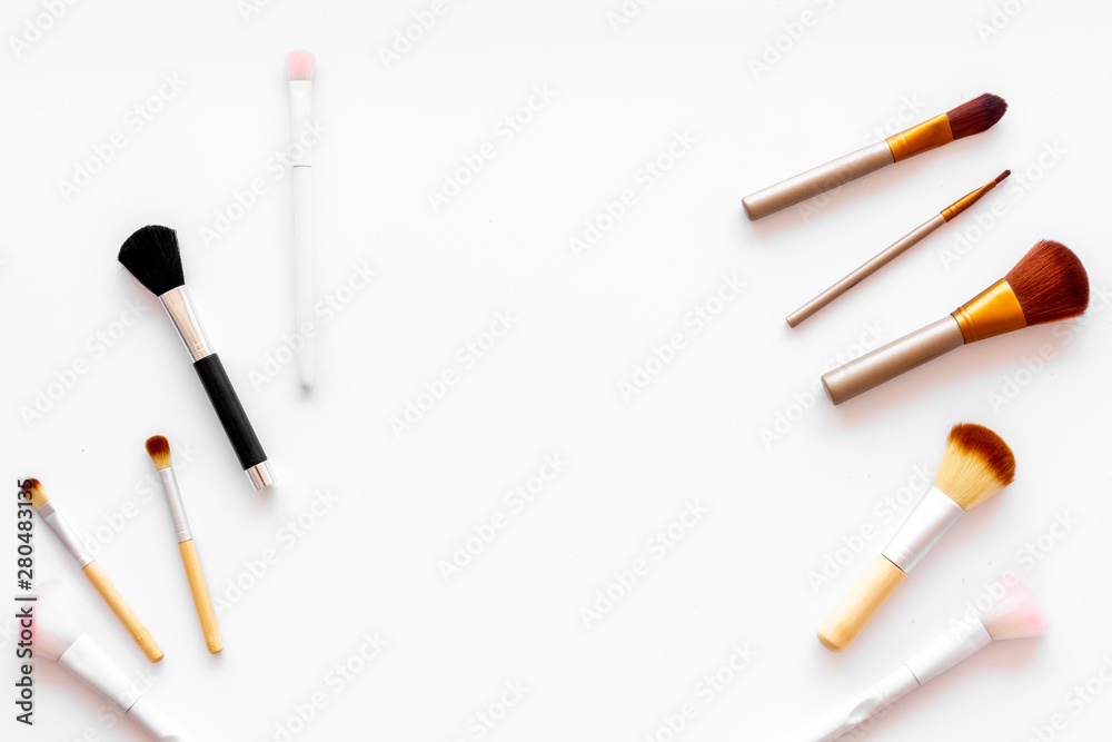 Brushes for make up on white visagiste work desk background top view copyspace Brushes for make up on white visagiste work desk background top view copyspace