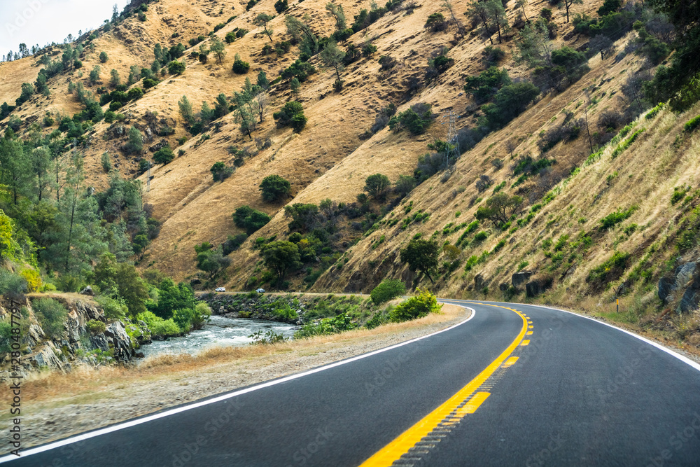 Travelling on Highway 140 along Merced river towards Yosemite National Park, Mariposa county, California