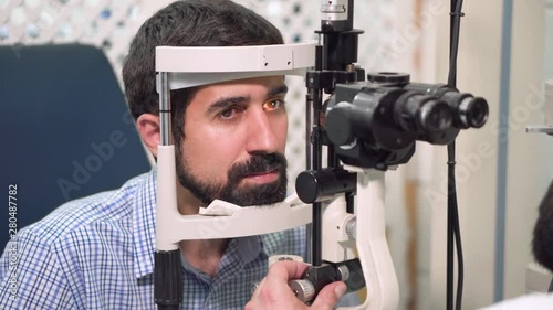 Ophthalmologist Checks young man eyesight - Patient In Ophthalmology Clinic .