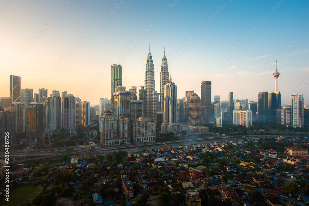Kuala Lumpur city skyline and skyscrapers building during sunrise at business district downtown in Kuala Lumpur, Malaysia. Asia..