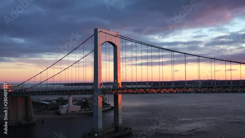 Pull out drone shot of throgs neck bridge during beautiful sunset photo