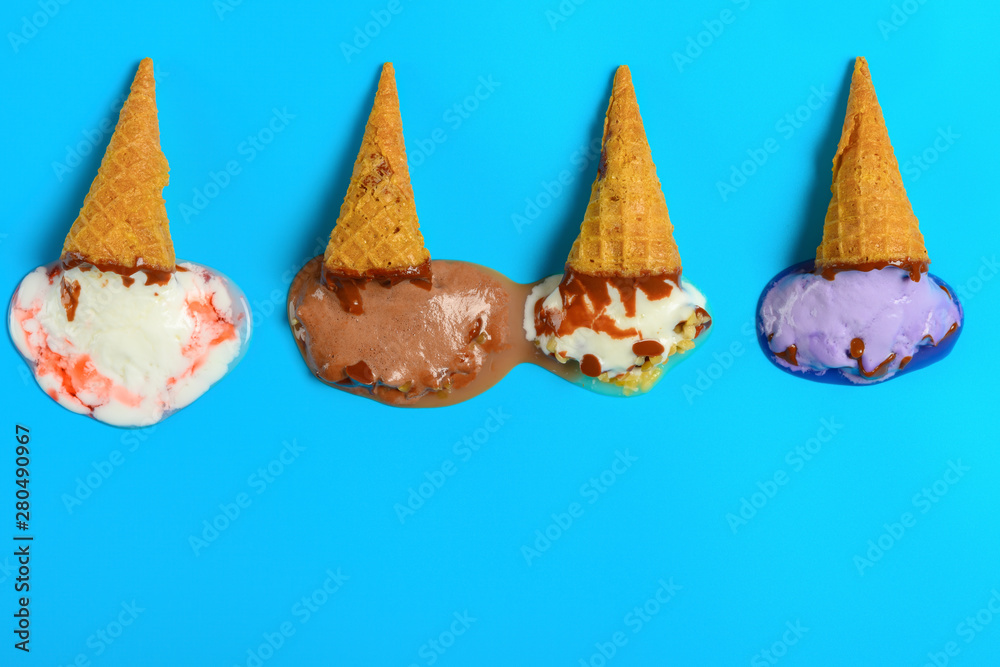 top view mini ice cream cones in a melting process on a blue background