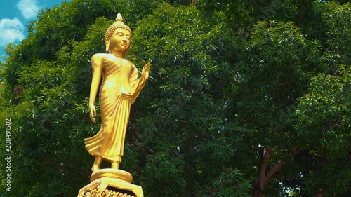 A beautifully sculpted statue of a golden female Budah stands proud in Chonburi, Thailand, Asia, photo