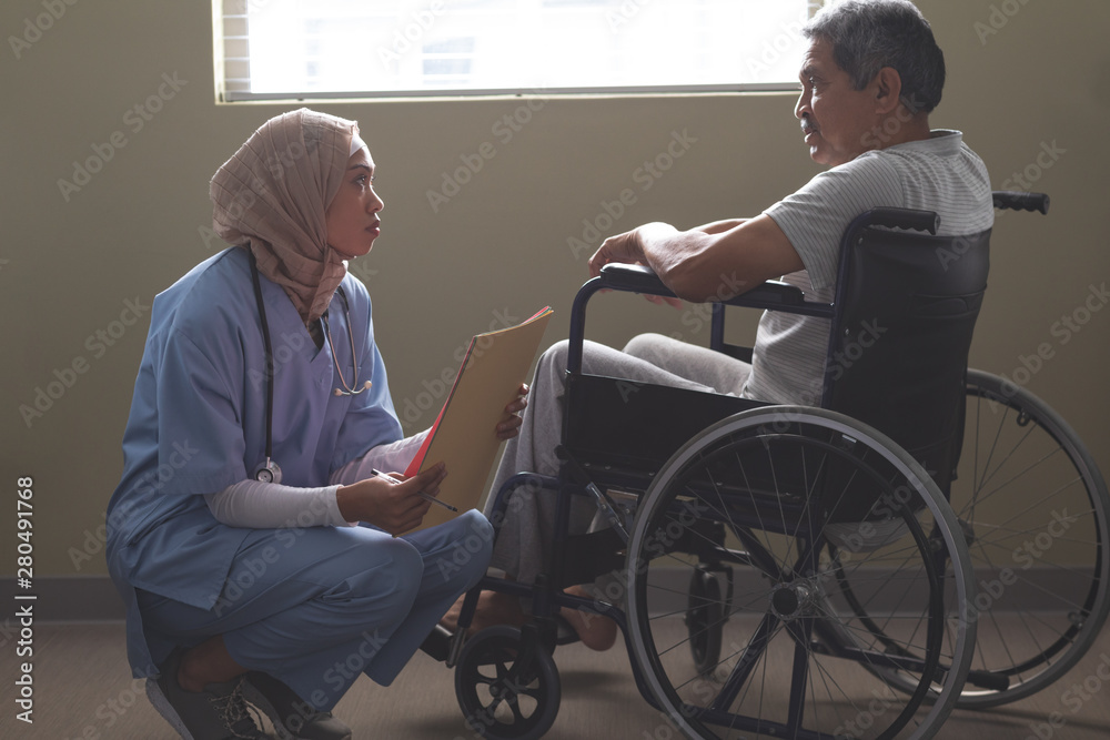 Female patient interacting with disabled male patient in the ward Female patient interacting with disabled male patient in the ward