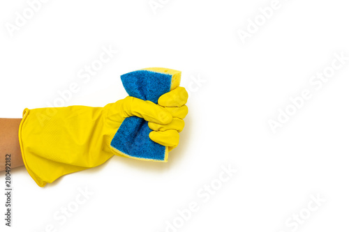 hand in yellow protective glove holding a bottle of sponge for cleaning