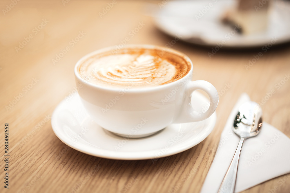 Hot coffee cappuccino latte art on wooden background Hot coffee cappuccino latte art on wooden background