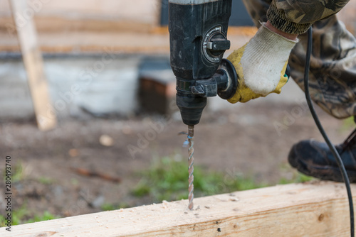 drill a hole in the board. Drill a hole in the timber. photo