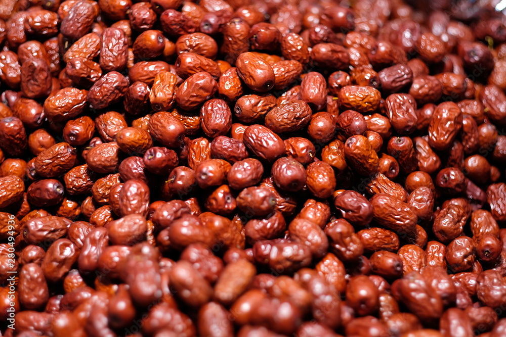 close up dense lots of fresh dried red dates in market under lamplight. beautiful attractive bright reflection. nutritious healthy sweet diet concept background close up dense lots of fresh dried red dates in market under lamplight. beautiful attractive bright reflection. nutritious healthy sweet diet concept background