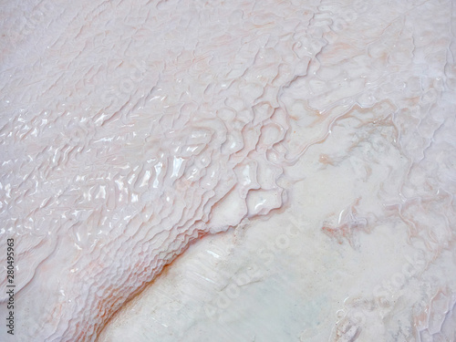 Obraz na płótnie Undulatory texture of white calcite stalactites covering a cascade of terraced baths in Pamukkale, Turkey