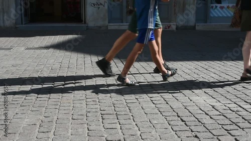 Legs of a woman followed from child and man in slow motion photo