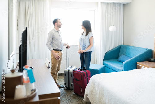 Newlyweds On Vacation In Hotel Room