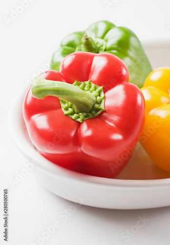 Bell peppers in a bowl on white background